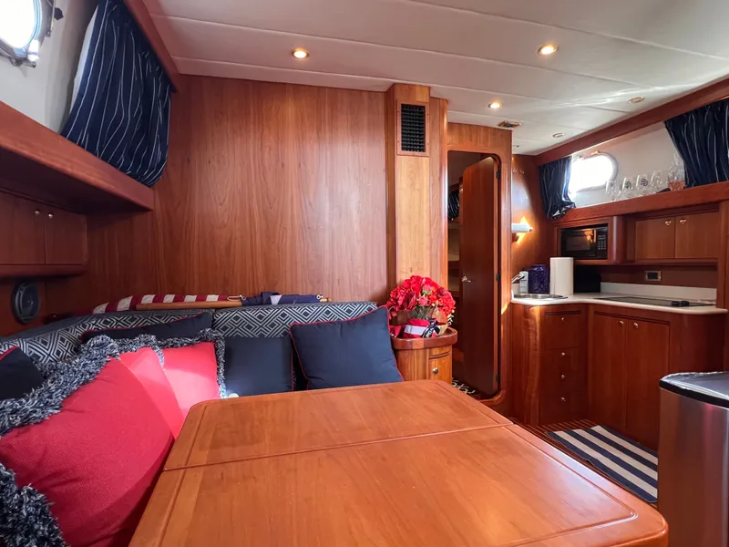 Slide: The Image of Interior of a 2003 Apreamare 40 yacht with wooden furnishings and cozy seating area. - 30