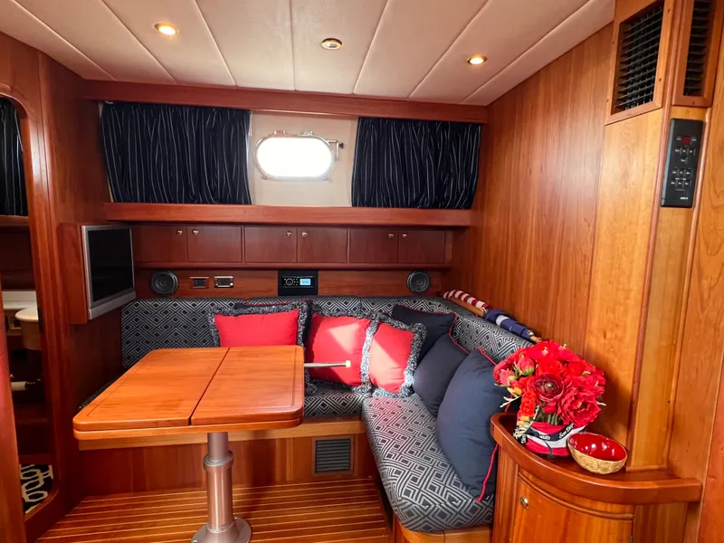 Slide: The Image of Interior of a 2003 Apreamare 40 yacht with wooden furnishings and cushions. - 37