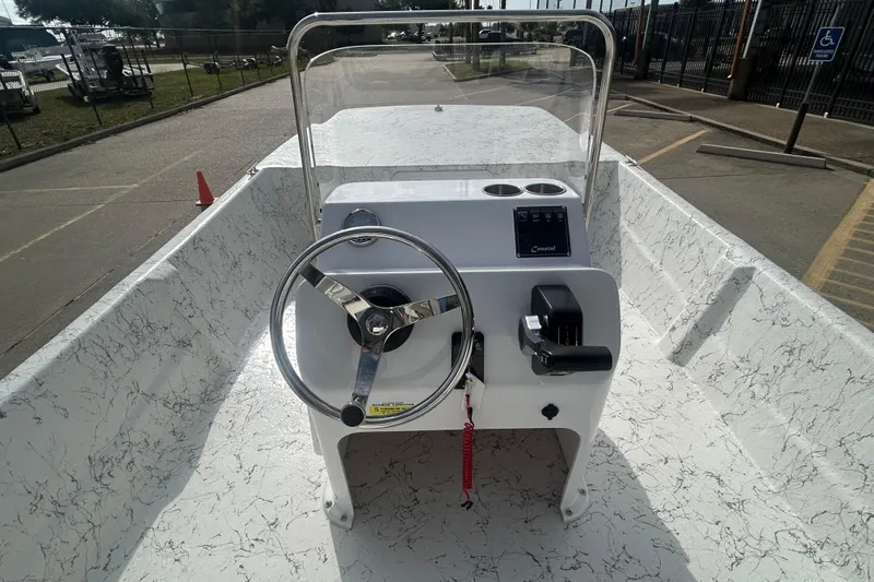 Slide: The Image of 2026 Coastal Skiff 184 boat interior with steering wheel and control panel. - 15