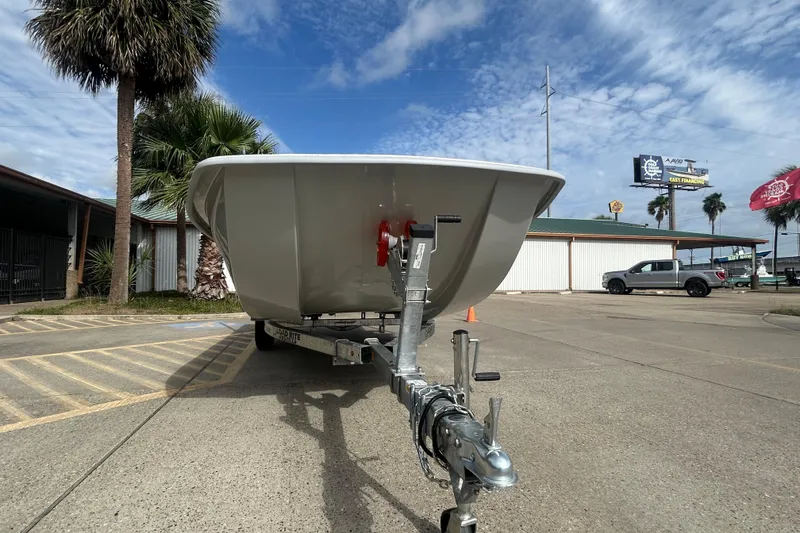 Slide: The Image of 2026 Coastal Skiff 184 boat on trailer in sunny outdoor setting. - 17