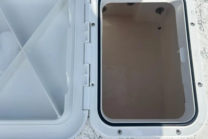 Slide: The Image of Open storage compartment on a 2026 Coastal Skiff 184 boat. - 21