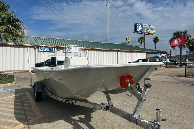 Slide: The Image of 2026 Coastal Skiff 184 boat on trailer at dealership, sunny day. - 3