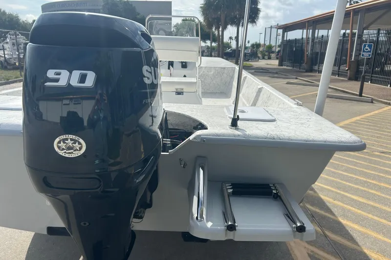 Slide: The Image of 2026 Coastal Skiff 184 boat with Suzuki 90 engine, parked outdoors. - 6