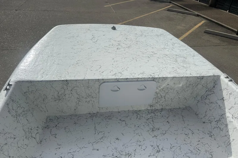 Slide: The Image of 2026 Coastal Skiff 184 boat deck with textured surface in a parking lot. - 7