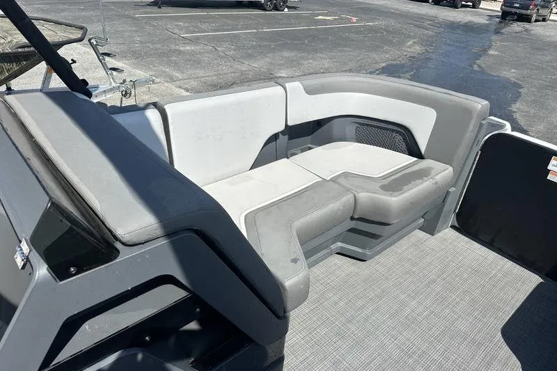 Slide: The Image of 2024 Manitou 24 X-Plode Cruise SHP boat interior with gray seating. - 13