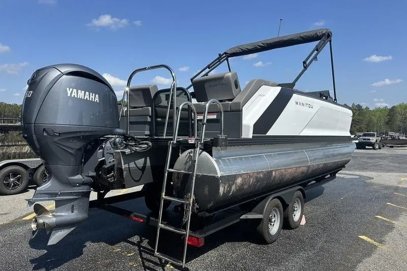 Slide: The Image of 2024 Manitou 24 X-Plode Cruise SHP pontoon boat with Yamaha engine on trailer. - 16