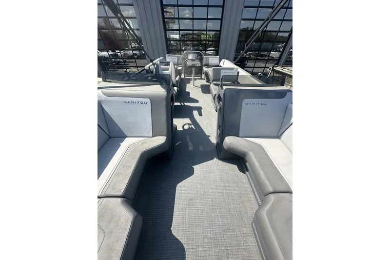 Slide: The Image of 2024 Manitou 24 X-Plode Cruise SHP pontoon boat interior with spacious seating. - 17