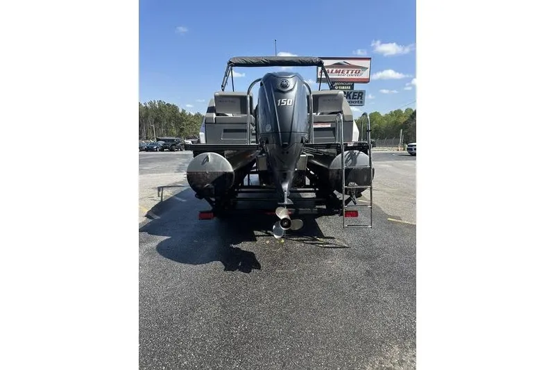 Slide: The Image of 2024 Manitou 24 X-Plode Cruise SHP pontoon boat with 150 HP engine, rear view. - 5