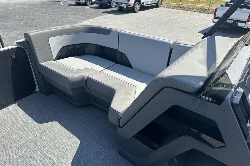 Slide: The Image of 2024 Manitou 24 X-Plode Cruise SHP boat interior with gray seating and modern design. - 7
