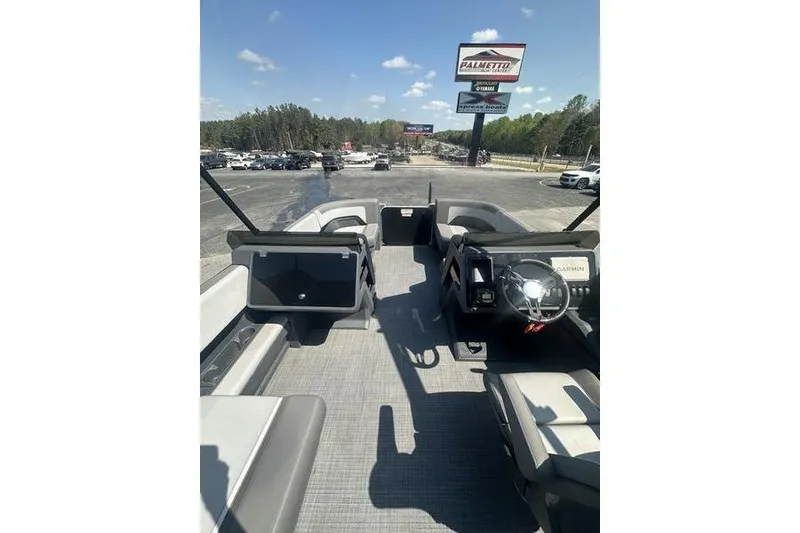 Slide: The Image of 2024 Manitou 24 X-Plode Cruise SHP pontoon boat interior with steering wheel and seating. - 8