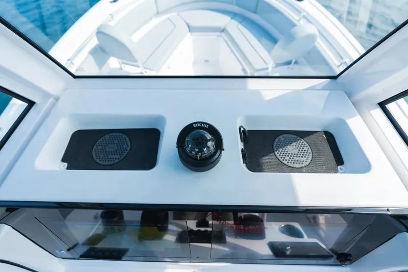 Slide: The Image of 2026 Sportsman Heritage 231 Center Console dashboard with compass and speakers. - 6