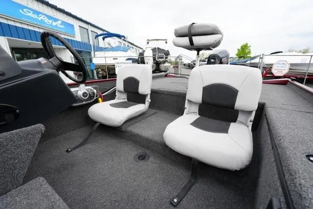 Slide: The Image of 2024 Crestliner 1600 Storm boat interior with two cushioned seats and steering console. - 11