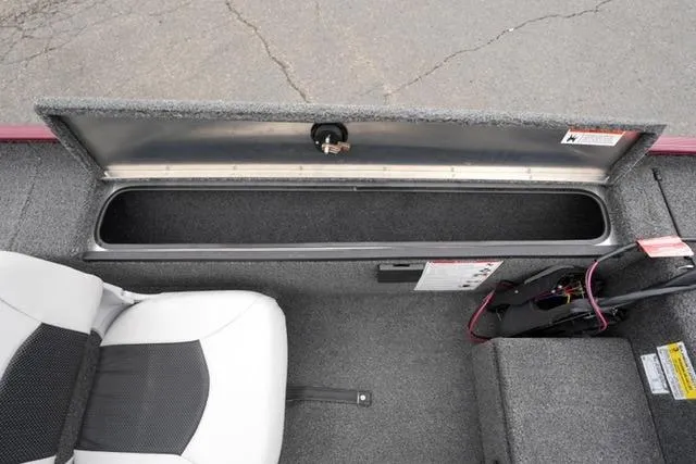 Slide: The Image of 2024 Crestliner 1600 Storm boat interior with open storage compartment and seating. - 13