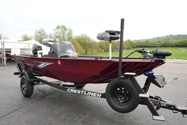 Slide: The Image of 2024 Crestliner 1600 Storm boat on trailer, maroon color, parked outdoors. - 3
