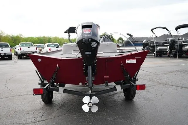Slide: The Image of 2024 Crestliner 1600 Storm boat, rear view, parked on a trailer in a lot. - 6