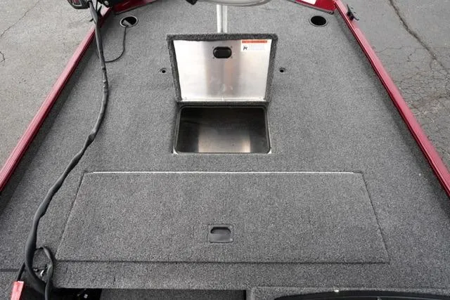Slide: The Image of 2024 Crestliner 1600 Storm boat deck with storage compartments, featuring gray carpeting. - 9