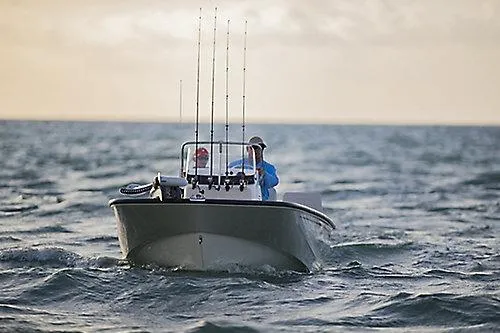 Slide: The Image of 2027 Boston Whaler 170 Montauk boat navigating ocean waves, equipped for fishing. - 6