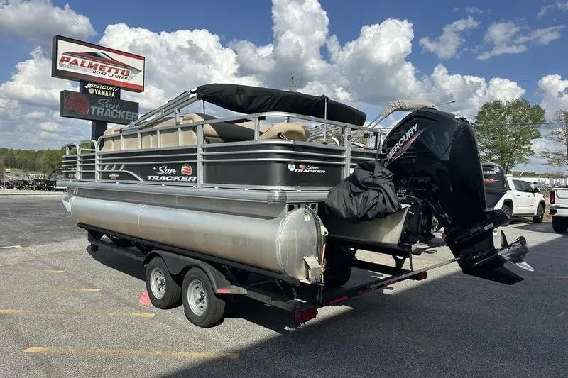 Slide: The Image of 2023 Sun Tracker Fishin' Barge 21 pontoon boat on trailer at dealership. - 3