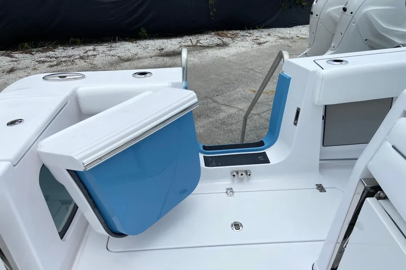 Slide: The Image of 2026 Sportsman Open 302 Center Console boat with blue and white interior details. - 16