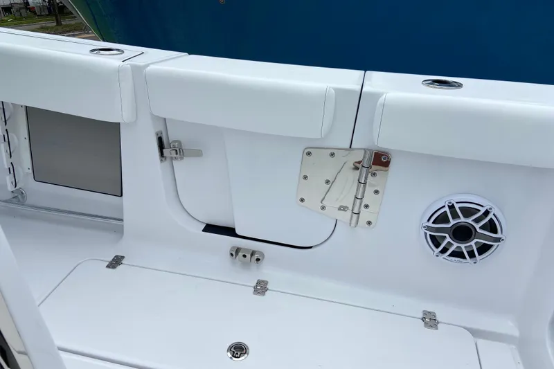 Slide: The Image of 2026 Sportsman Open 302 Center Console boat interior with speaker and storage compartment. - 17