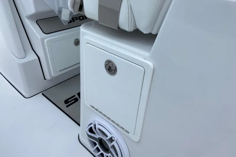 Slide: The Image of 2026 Sportsman Open 302 Center Console interior with storage compartment and speaker. - 21