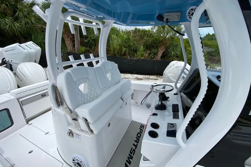 Slide: The Image of 2026 Sportsman Open 302 Center Console boat interior with white seating and modern controls. - 23