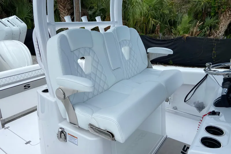 Slide: The Image of 2026 Sportsman Open 302 Center Console boat with luxurious white seating and modern design. - 25