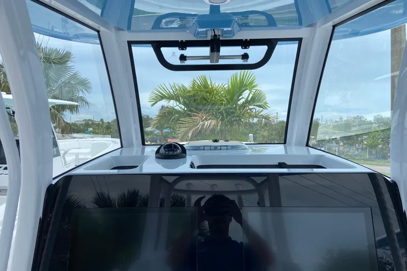 Slide: The Image of Interior view of 2026 Sportsman Open 302 Center Console boat with clear windshield. - 26