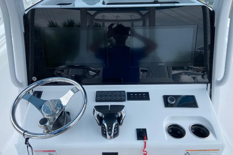 Slide: The Image of 2026 Sportsman Open 302 Center Console helm with dual displays and modern controls. - 27