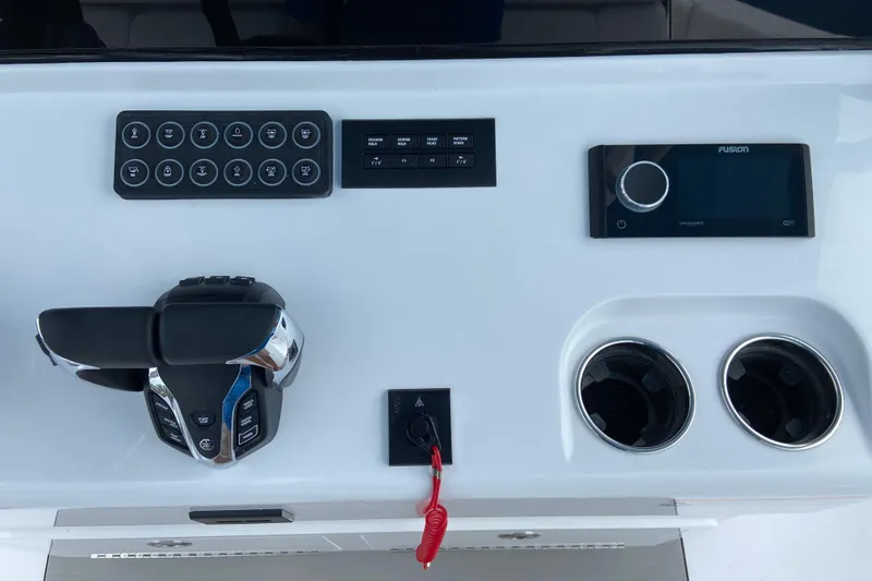 Slide: The Image of 2026 Sportsman Open 302 Center Console dashboard with controls and cup holders. - 28