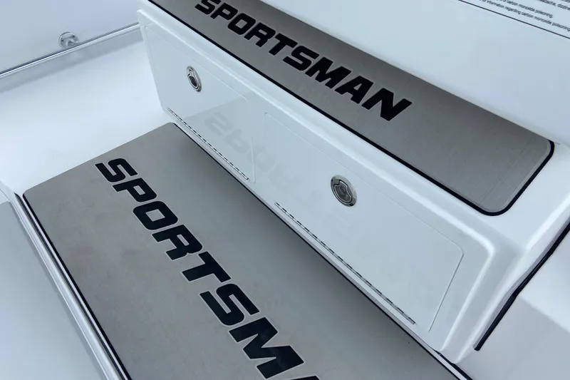 Slide: The Image of 2026 Sportsman Open 302 Center Console boat deck with branded storage compartments. - 31