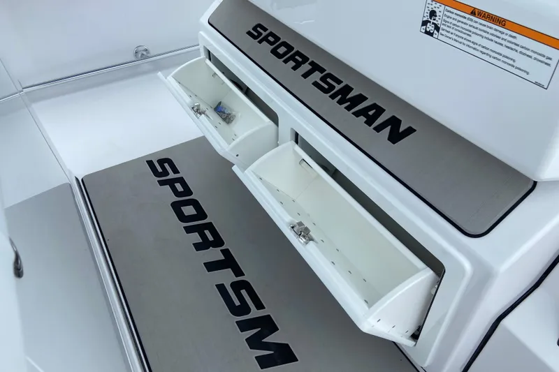 Slide: The Image of 2026 Sportsman Open 302 Center Console with storage compartments and branding. - 32