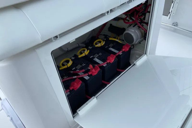Slide: The Image of 2026 Sportsman Open 302 Center Console battery compartment with multiple batteries and wiring. - 34