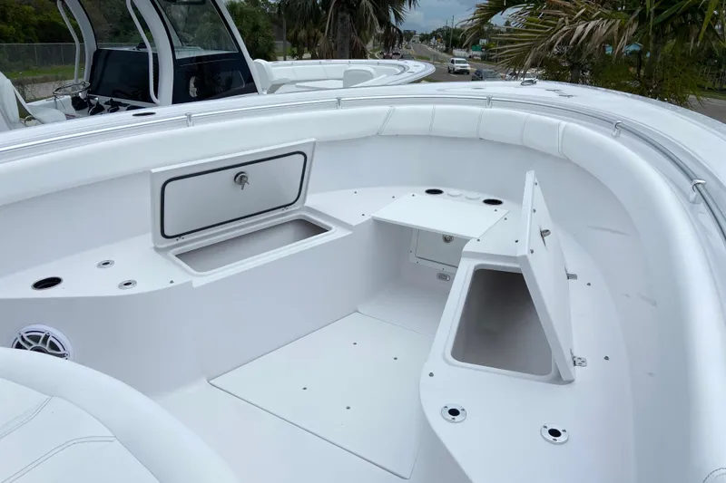 Slide: The Image of 2026 Sportsman Open 302 Center Console boat interior with storage compartments. - 36