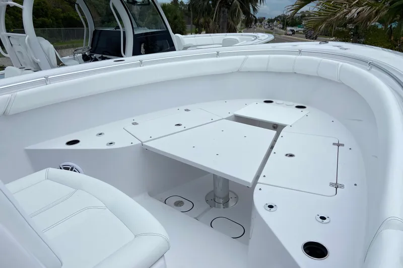 Slide: The Image of 2026 Sportsman Open 302 Center Console boat interior with white seating and table. - 37