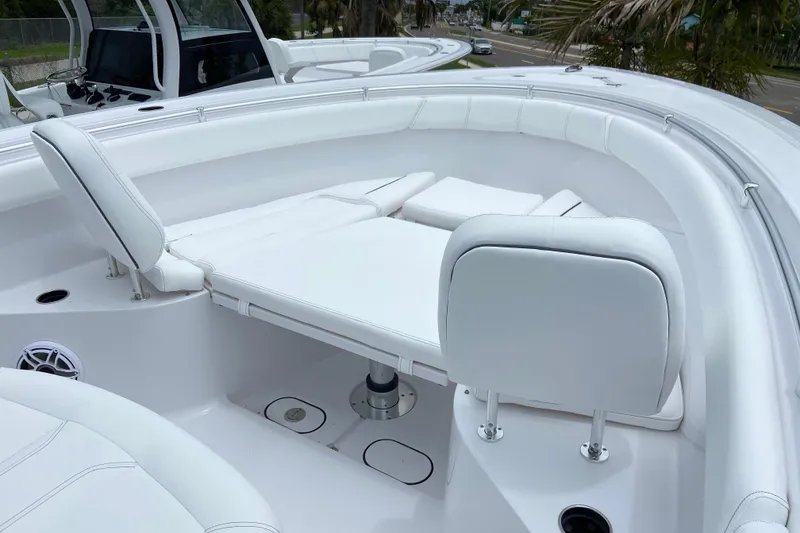 Slide: The Image of 2026 Sportsman Open 302 Center Console boat with white cushioned seating area. - 39