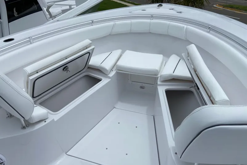 Slide: The Image of 2026 Sportsman Open 302 Center Console boat with white seating and storage compartments. - 41