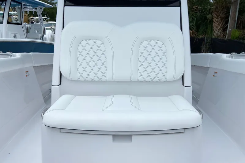 Slide: The Image of 2026 Sportsman Open 302 Center Console boat with white cushioned seating. - 45