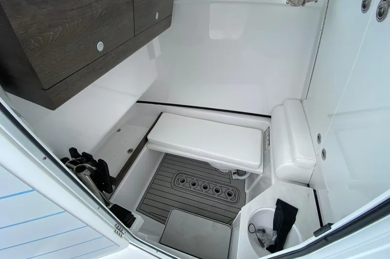 Slide: The Image of 2026 Sportsman Open 302 Center Console interior with seating and storage. - 49