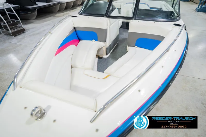Slide: The Image of Interior of a 1992 MasterCraft ProStar boat with white and blue seating. - 11