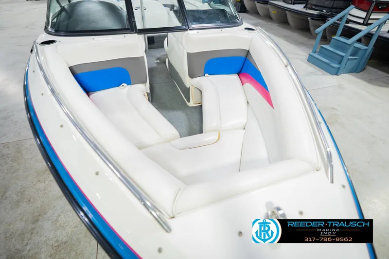 Slide: The Image of 1992 MasterCraft ProStar boat interior with white seating and colorful accents. - 12
