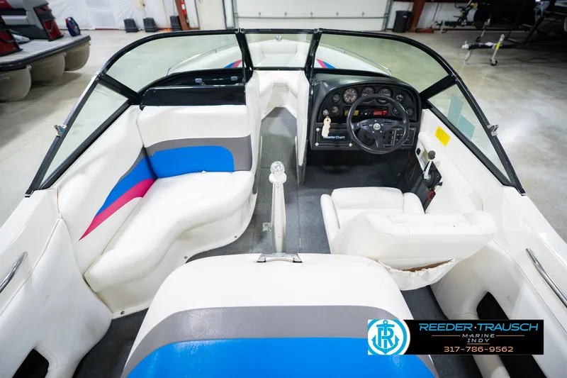 Slide: The Image of 1992 MasterCraft ProStar boat interior with white, blue, and pink seating in showroom. - 16
