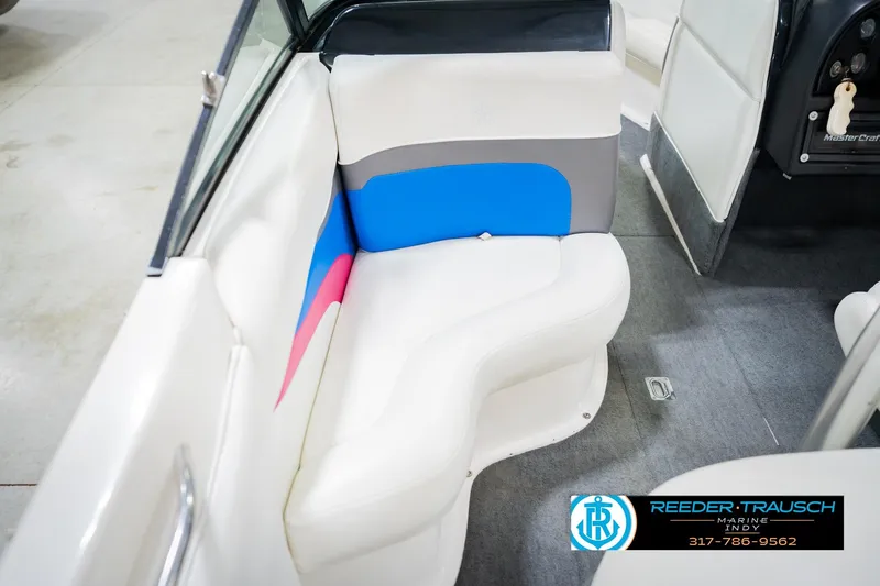 Slide: The Image of Interior of a 1992 MasterCraft ProStar boat with white seating and colorful accents. - 21