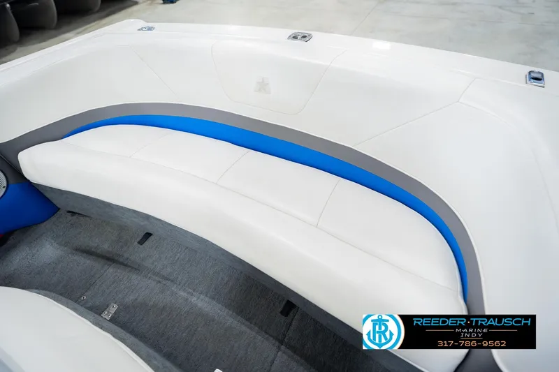 Slide: The Image of Interior of a 1992 MasterCraft ProStar boat with white, pink, and blue seating. - 38