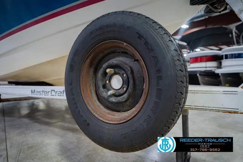 Slide: The Image of Close-up of a 1992 MasterCraft ProStar boat's metal cleat on blue surface. - 52