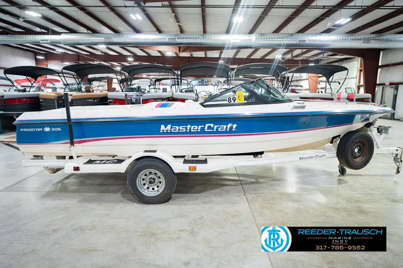 Slide: The Image of 1992 MasterCraft ProStar boat in a garage, showcasing "World Record Ski Boats" branding. - 6