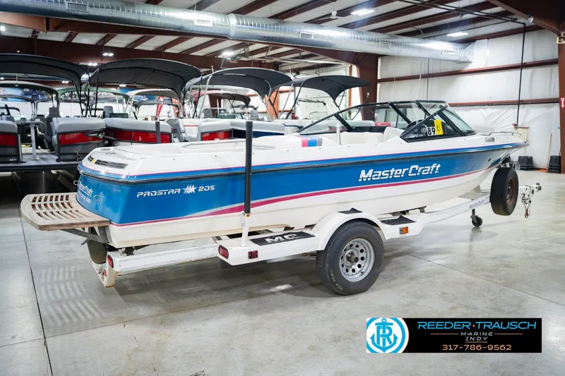 Slide: The Image of 1992 MasterCraft ProStar boat on trailer in indoor showroom. - 7