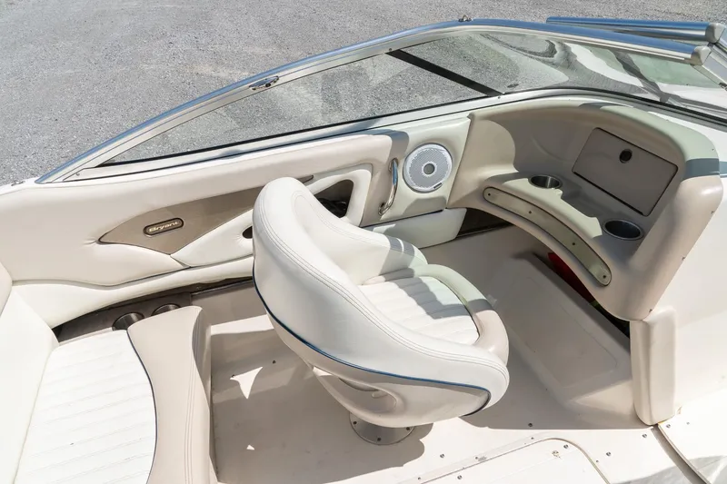 Slide: The Image of Interior of a 2007 Bryant 190 boat featuring white seating and dashboard. - 12