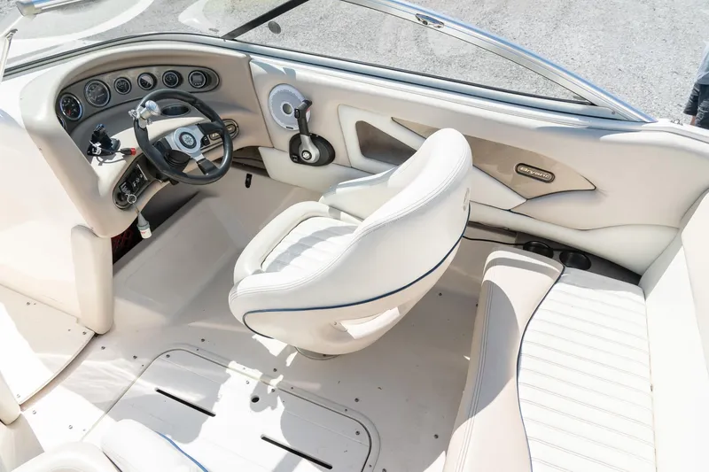 Slide: The Image of Interior of a 2007 Bryant 190 boat featuring steering wheel and seating. - 13