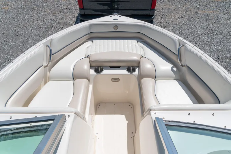 Slide: The Image of 2007 Bryant 190 boat interior with white seating and cup holders. - 15